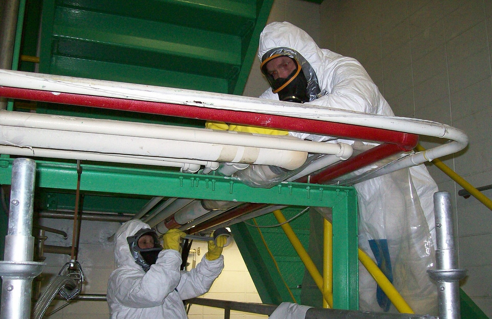 Protected workers completing asbestos removal at a federal facility