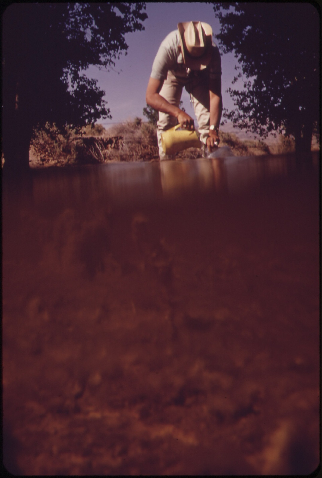EPA technician collecting a field water sample from Pahranagat Lake