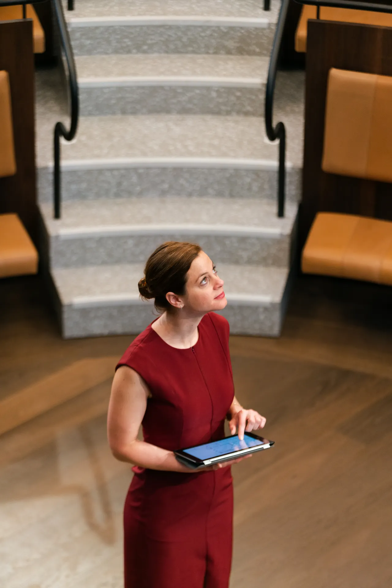A professional using a tablet while observing a commercial building interior